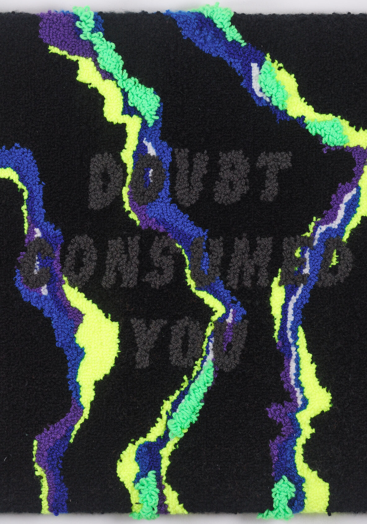 Fabric glued together in neon green, blue, yellow, and black with text