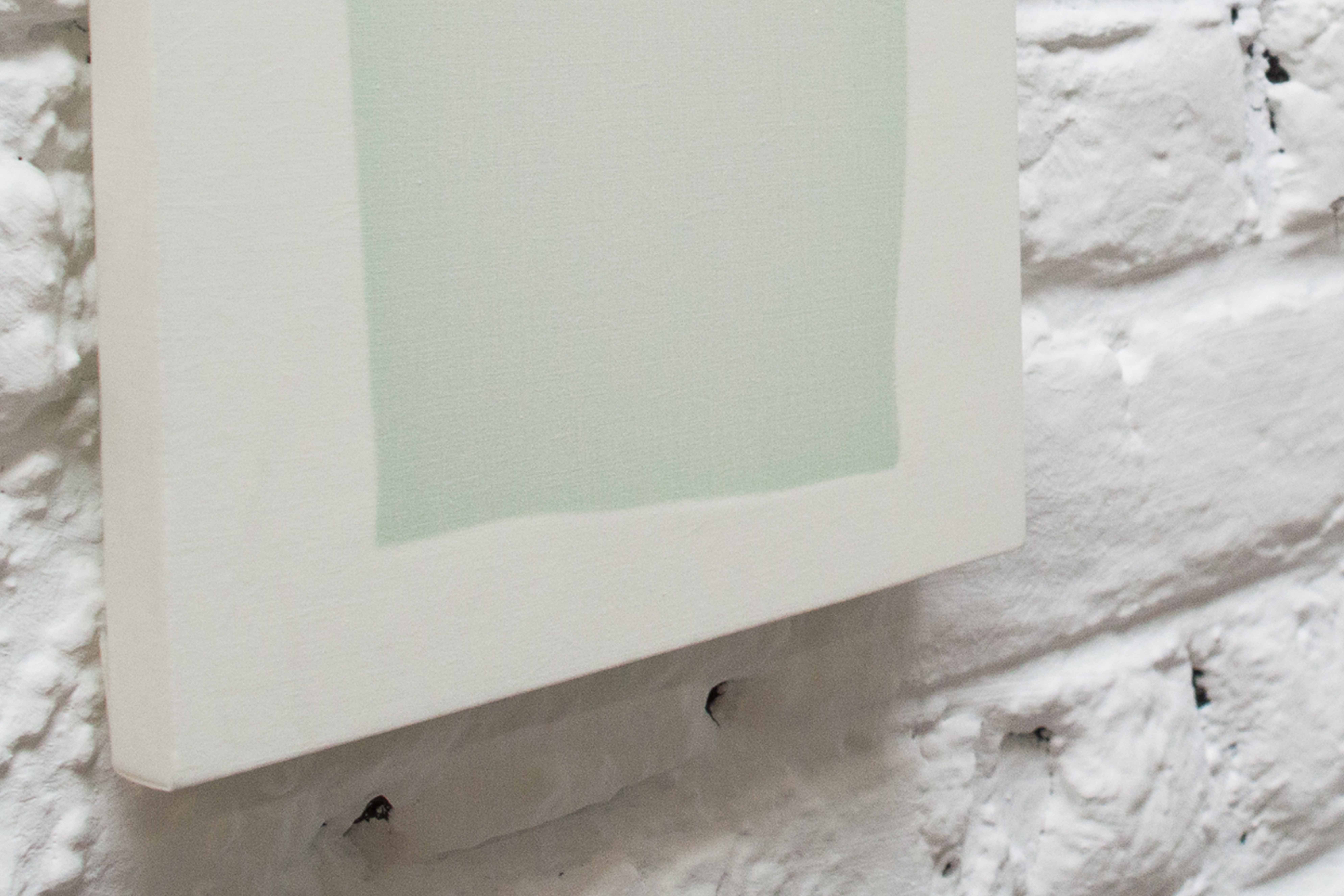 Light green square against a white background