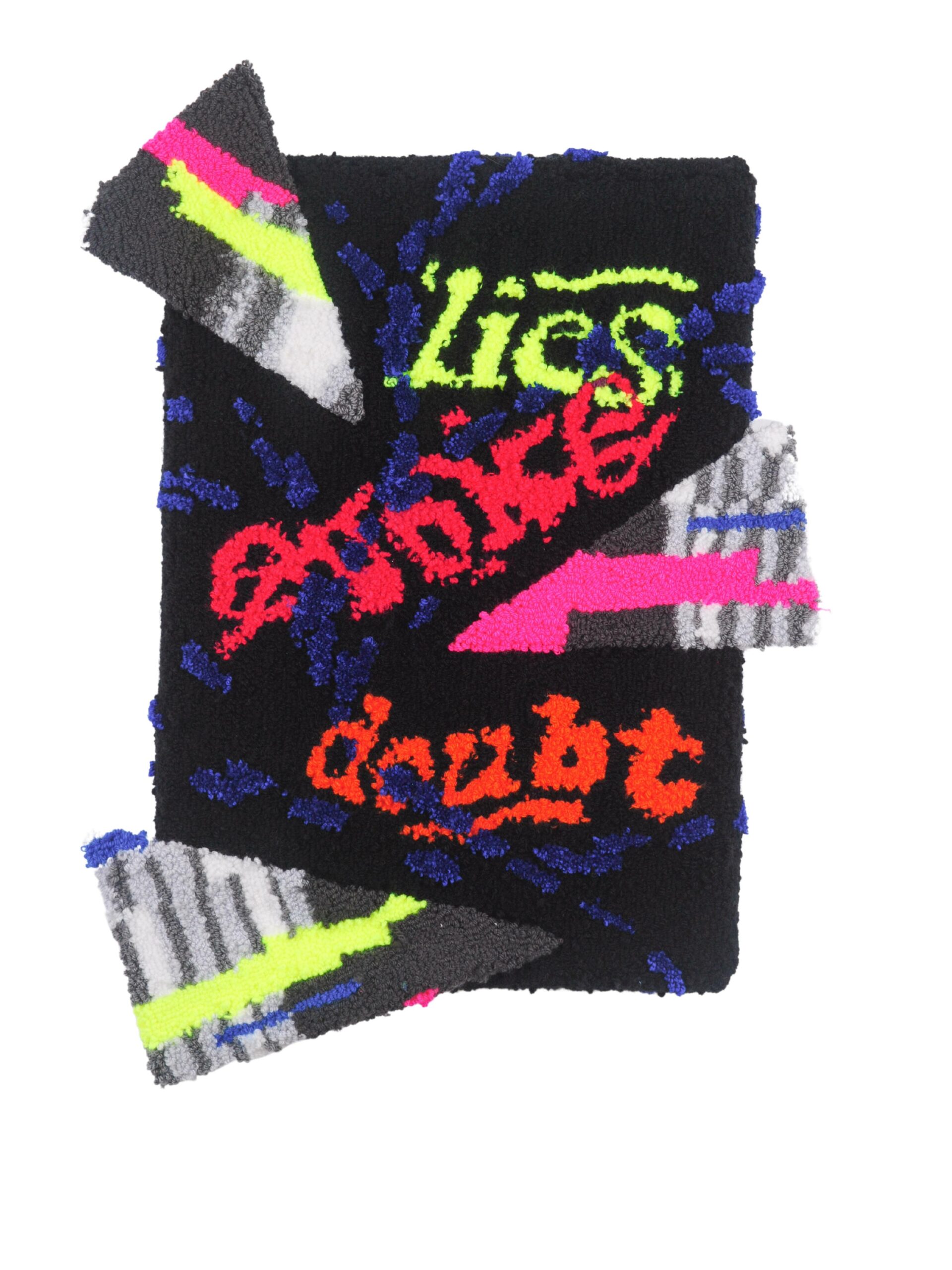 Multicolored fabric pieces glued together with text saying lies evoke doubt