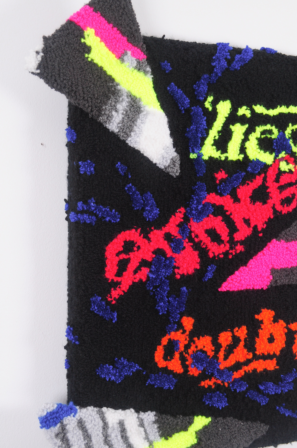 Multicolored fabric pieces glued together with text saying lies evoke doubt