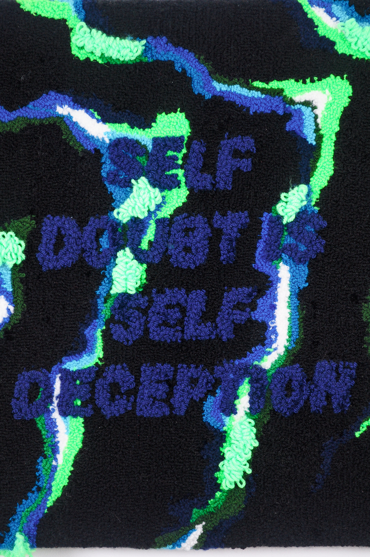 Fabric glued together in neon green, blue, and black with text