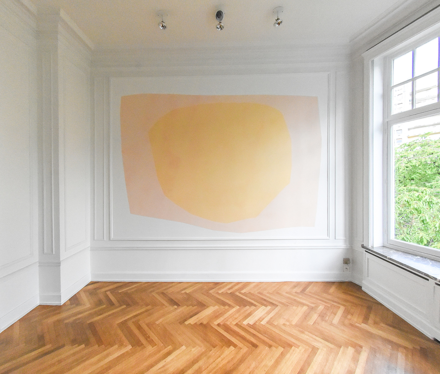 Painting of a yellow sun against a lighter yellow backdrop made from cotton cloth