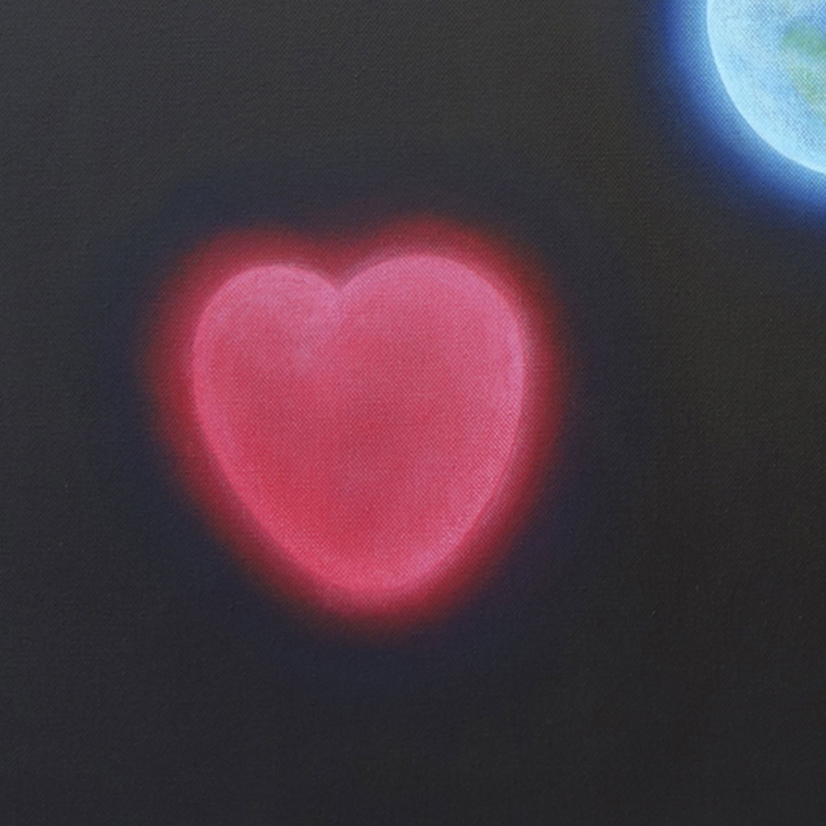 Red heart and blue planet earth against a black background
