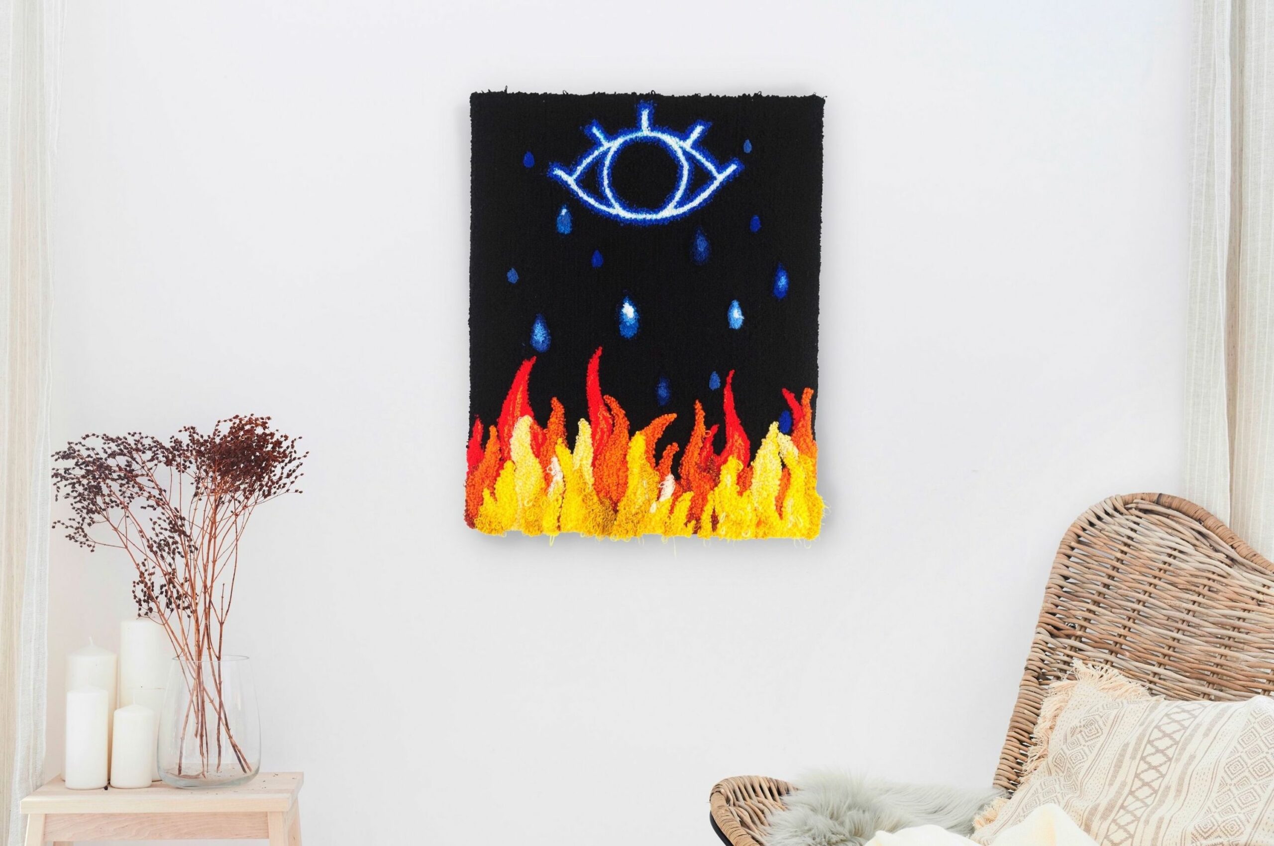 Yellow and red flames beneath the outline of an eye in blue against a black backdrop